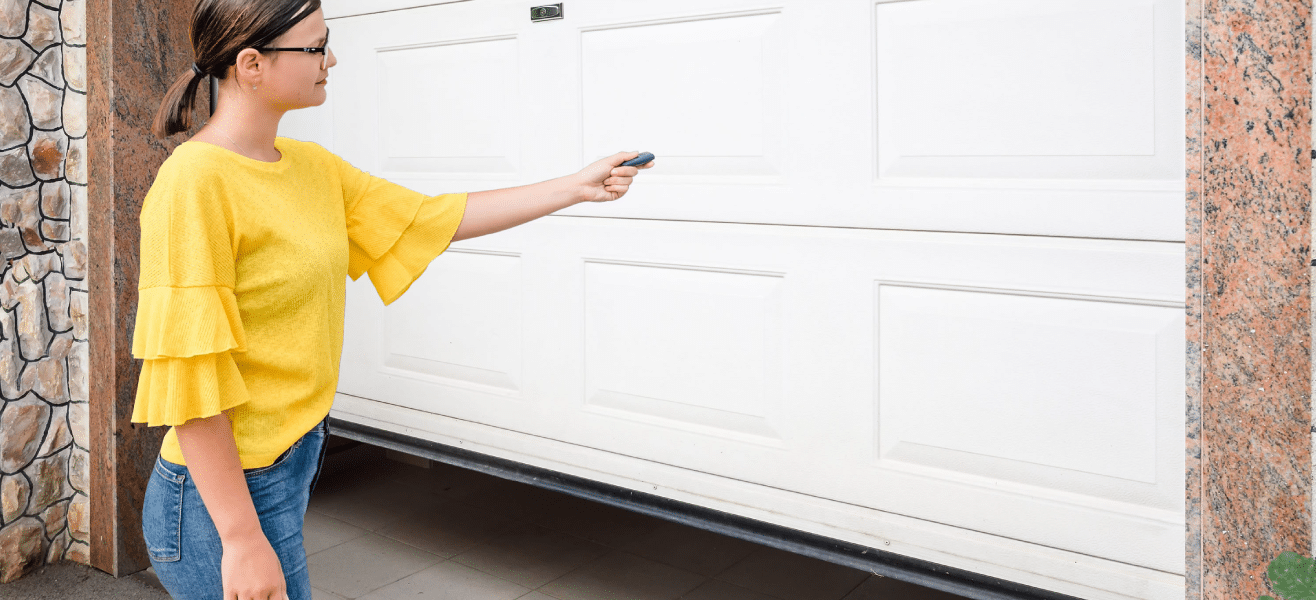 how to manually open a garage door - with a girl holding garage door remote